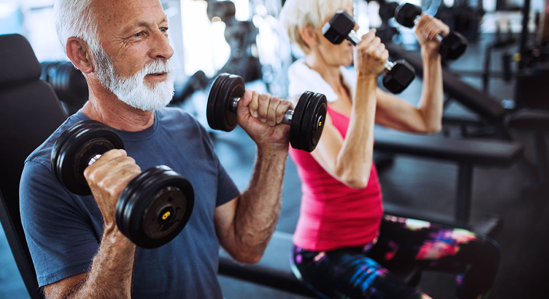 A senior couple working out together in a gym