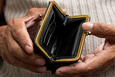 Elder woman's hands opening an empty coin purse