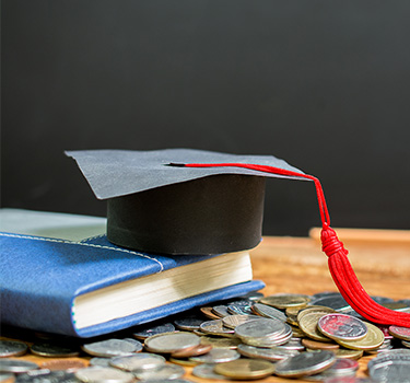 Book, mortarboard and college tuition in change