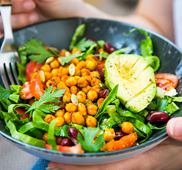 a bowl of salad made up of a plant based diet