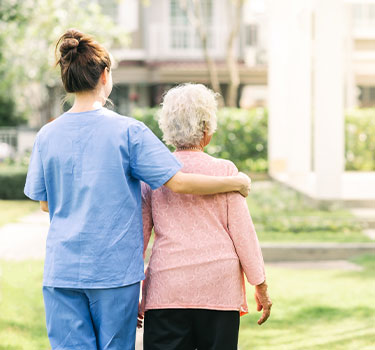 a caregiver with their arm around a senior