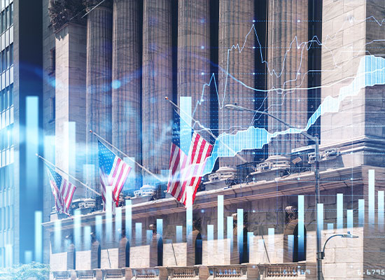 Composite image showing american flags in front of a building overlaid with stock market graphs and charts, depicting economic concepts and trends.