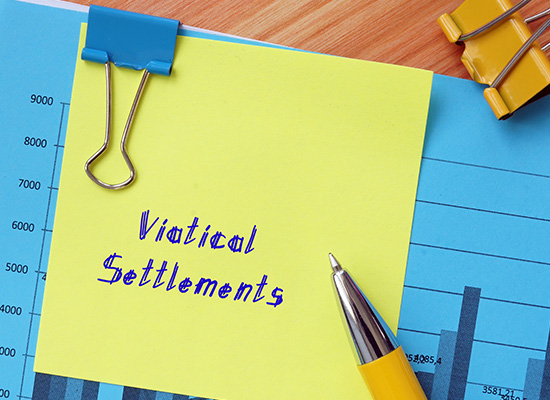 A yellow sticky note with the words 'Viatical Settlements' written in blue ink, clipped to a graph, highlighting the financial planning aspect of viatical settlements.