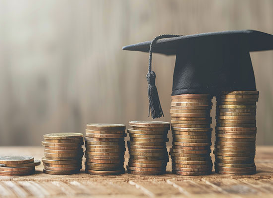 Stacked coins gradually increase in height, topped with a graduation cap, illustrating the link between education, income, and retirement savings.