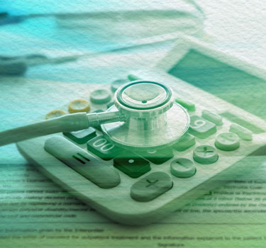 Stethoscope resting on a calculator symbolizes financial planning concepts