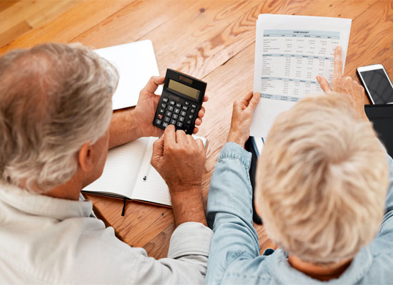 Senior couple reviewing retirement savings plans and contributions