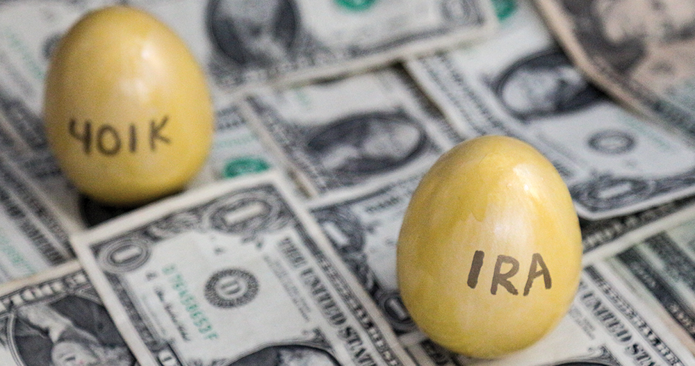 401K and IRA labeled on two eggs sitting on top of money