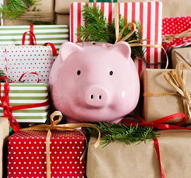 Piggy bank with Christmas gifts under the tree