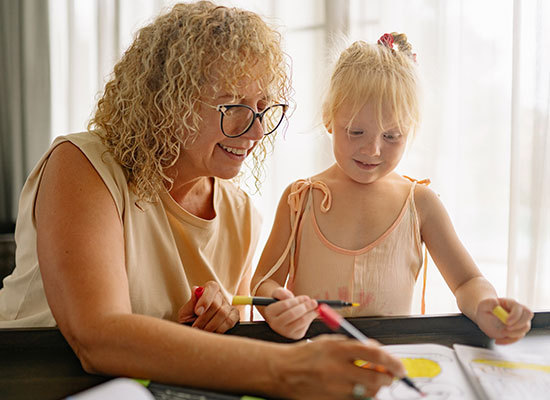 grandmother and grandchild painting together