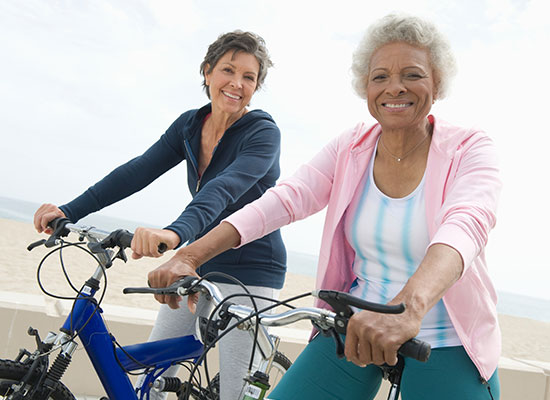 two friends riding bikes together for exercise