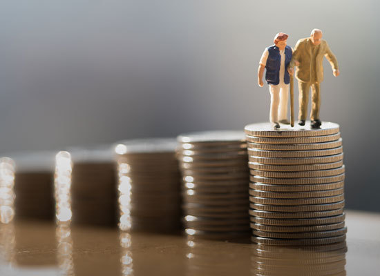 two figure people standing on a stack of coins