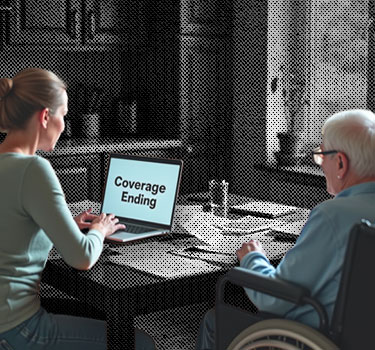 A concerned woman sits at a table with an elderly man in a wheelchair, looking at a laptop screen that reads 'Coverage Ending'