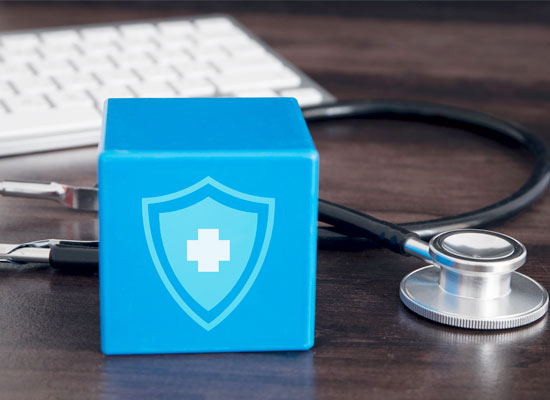 Blue cube with a health shield icon next to a stethoscope