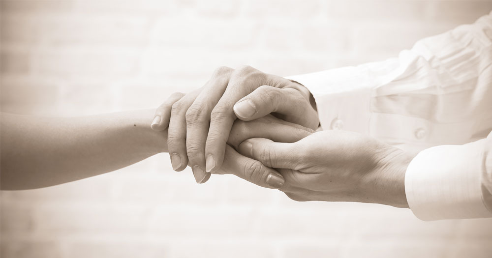 Black and white image of holding hands