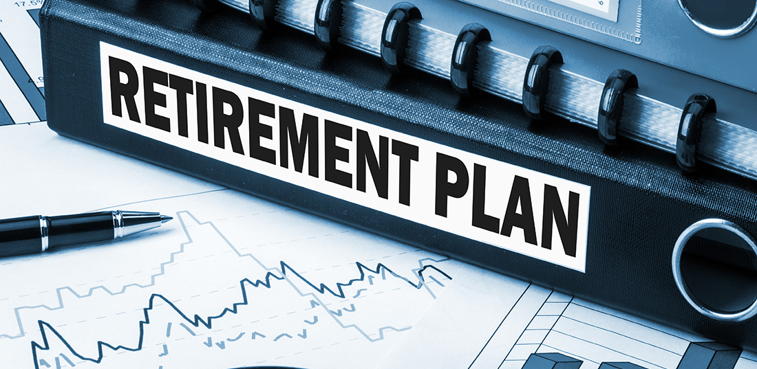 Retirement plan documents on desk with graphs