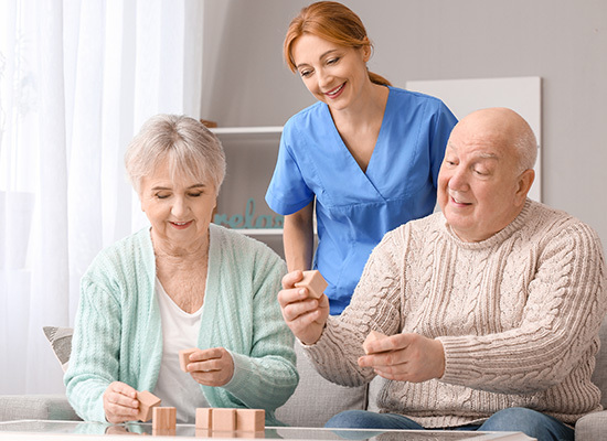 nurse assisting elderly couple