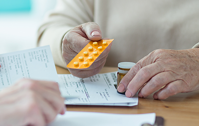 Woman holding a handful of perscription medication