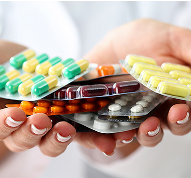 Woman holding a handful of perscription medication
