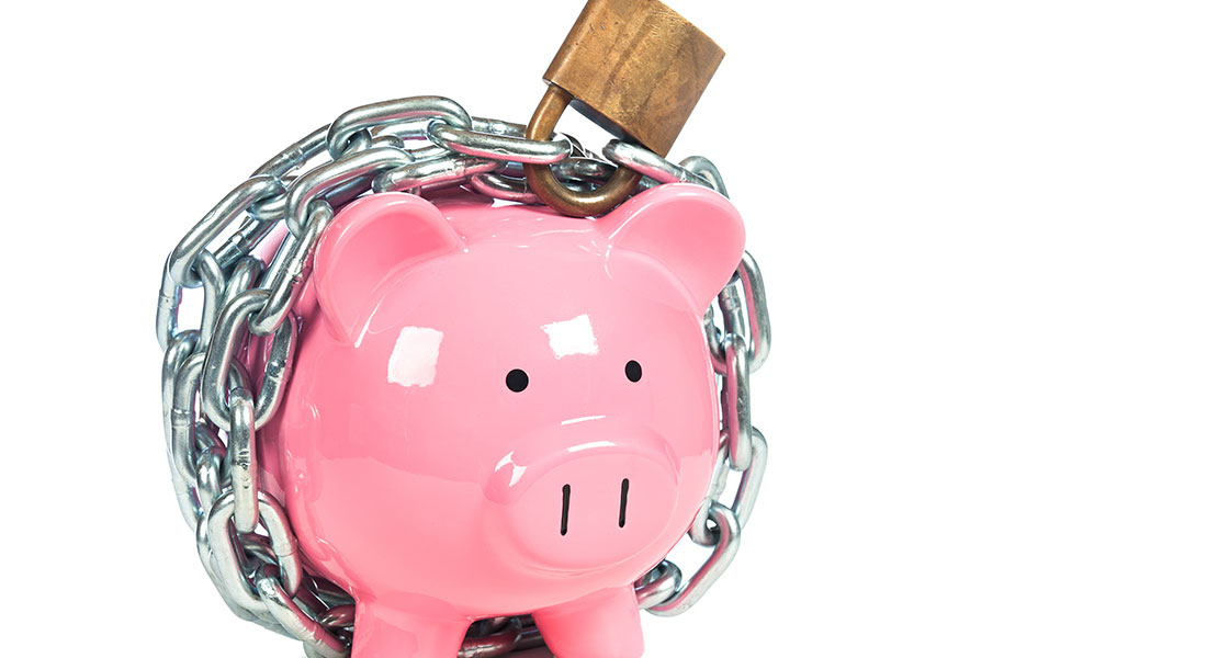 A piggy bank locked up with a chain