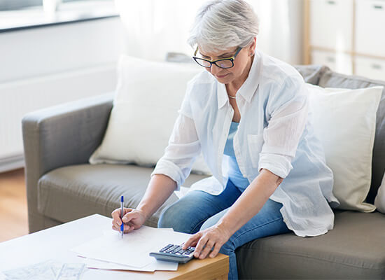 ELderly woman working on retirement documents