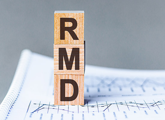 wooden blocks that spell RMD stcked on top of a graph