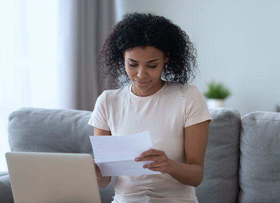 person looking over document on laptop