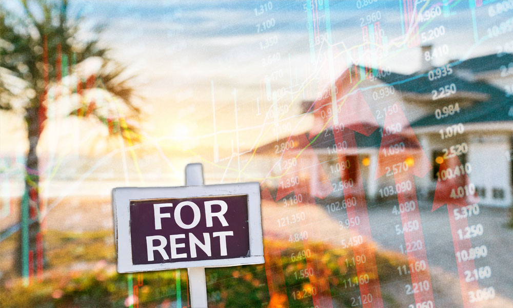 a for rent sign with a beach house in the background