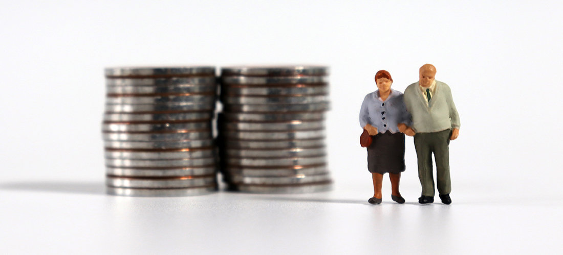 Clay figurine couple standing next to stacks of nickels