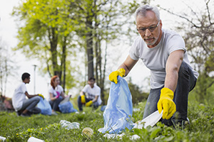 Older man volunteering to clean up a park