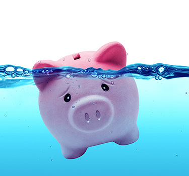 Sad piggy bank sinking underwater