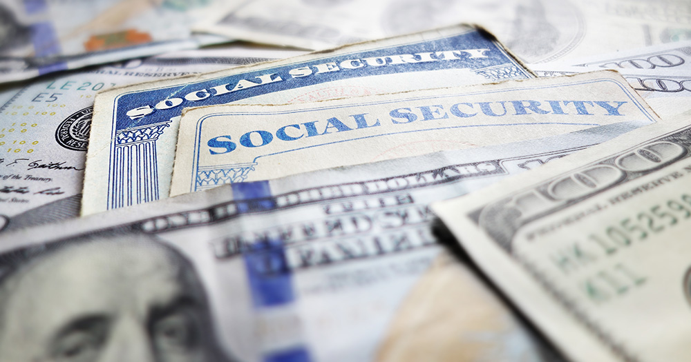 Social Security Card surrounded by $100 dollar bills