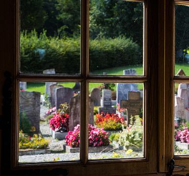Church window looking out over cemetery