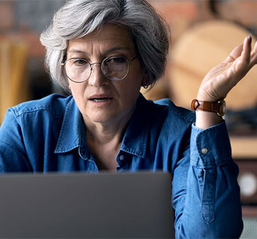Elderly woman checking her online accounts