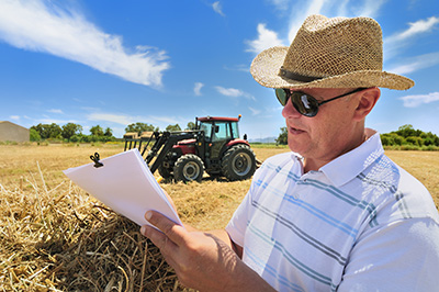 Senior farmer managing his farm and paperwork