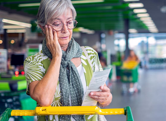 woman in a grocery stored socked at receipt