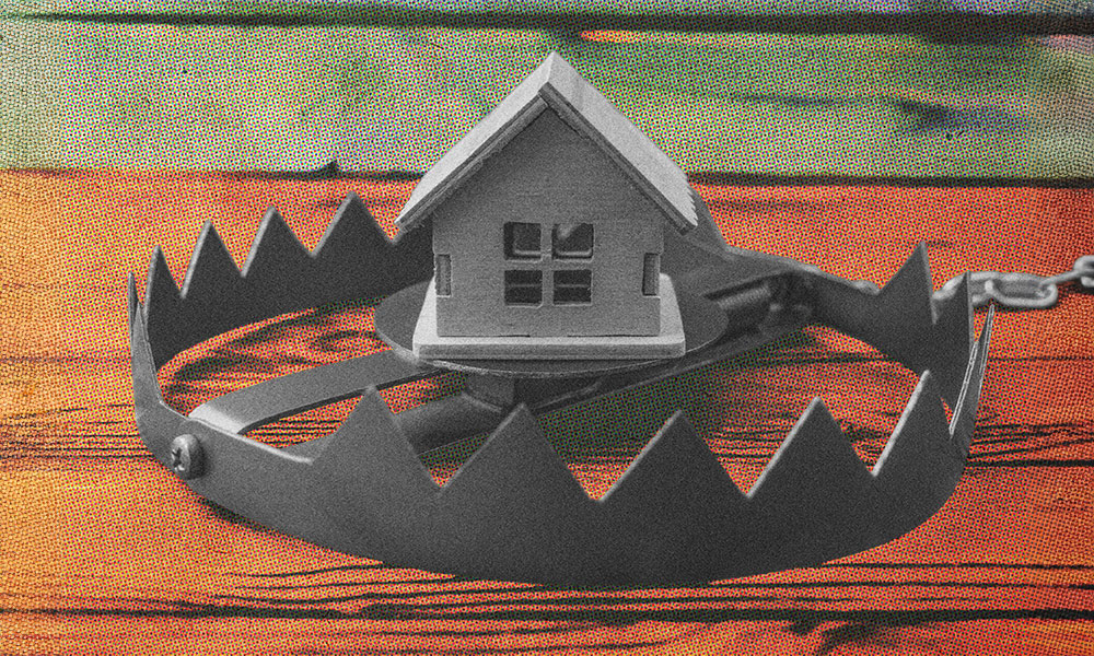 A small wooden house rests precariously within the jaws of a menacing bear trap set on a wooden surface, warning of real estate scams.