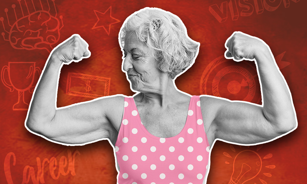 Retired woman in pink and whit polkadot bathing suit flexing her arms