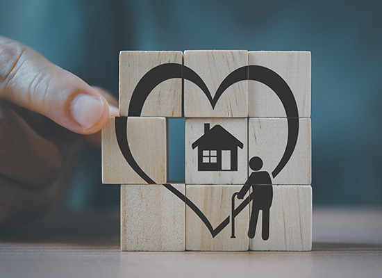 nine wooden blocks stacked showing an image of a elderly person looking at a house