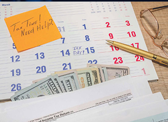 calendar on desk with money and tax return statement