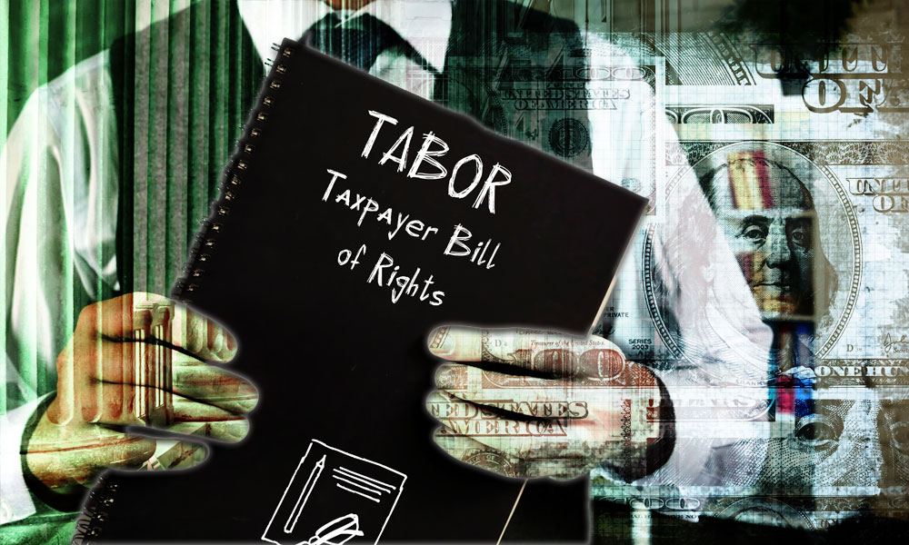 An individual holding a document labeled 'TABOR: Taxpayer Bill of Rights,' 